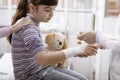 Doctor wrapping a bandage on a girl`s wrist Royalty Free Stock Photo