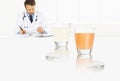 Doctor writes the medical prescription on a desk office with glass and aspirin tablets, cold and flu cure concept, web banner Royalty Free Stock Photo