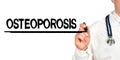 Doctor writes the word - OSTEOPOROSIS. Image of a hand holding a marker isolated on a white background