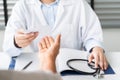 Doctor writing diagnosis and giving a medical prescription to senior women Patient