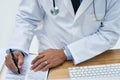Doctor, writing and hands of document with paper and medical research for rapamycin in office. Person, tech and lifetime Royalty Free Stock Photo