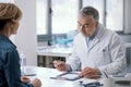 Doctor writing a medical prescription for his patient Royalty Free Stock Photo