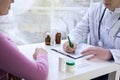 Male doctor writing patient notes on a medical examination or prescription Royalty Free Stock Photo