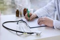 Male doctor writing patient notes on a medical examination or prescription Royalty Free Stock Photo