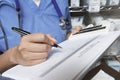 Doctor Writing In Patient's Medical Chart Royalty Free Stock Photo