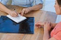 Doctor writing a prescription for her patient in medical office Royalty Free Stock Photo