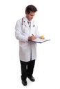 Doctor writing up patient record Royalty Free Stock Photo