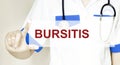 Doctor writing word BURSITIS with hands, Medical concept