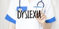 Doctor writing word DYSLEXIA with marker, Medical concept Royalty Free Stock Photo