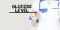 Doctor writing word Glucose Level with marker, Medical concept Royalty Free Stock Photo