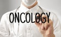 Doctor writing word ONCOLOGY with marker, Medical concept
