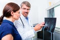 Doctor with x-ray picture of patient hand Royalty Free Stock Photo