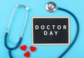 Doctor's Day concept, flat lay top view, stethoscope with red heart and black board Royalty Free Stock Photo