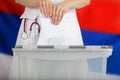 Doctor& x27;s hand casts ballot paper in the ballot box. Royalty Free Stock Photo