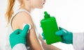 Doctor's hands with cotton wool and antiseptic treating the skin before vaccination against tetanus and viral Royalty Free Stock Photo