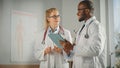 Doctor& x27;s Office: Black Physician Talks With Professional Head Nurse, Using Tablet Computer Royalty Free Stock Photo