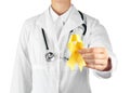Doctor with yellow ribbon on white background. Cancer awareness concept Royalty Free Stock Photo