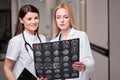 Professional doctors analyzing scan or x-ray film or explains CT scan together Royalty Free Stock Photo