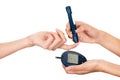 Doctors arm holding glucose meter scanner on patients finger and measure monitor in other hand