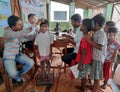 a doctors check up a students body at a primary school in rural india