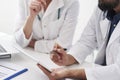 Close up of doctors checking results on digital tablet