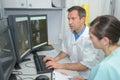 Doctors checking xray on computers screen on desk