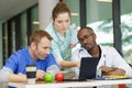 doctors in coffee break eat snacks together and talk Royalty Free Stock Photo