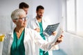 Doctors examining an x-ray report in hospital to make diagnosis Royalty Free Stock Photo