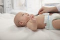 Doctors hand checking the heartbeat of a baby, close-up