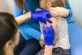 Doctors hand with syringe making kids vaccination Royalty Free Stock Photo