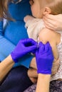 Doctors hand with syringe making kids vaccination Royalty Free Stock Photo