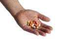 Doctors hand holding many colorful pills isolated on white background. Drugs, medication addiction. Drug abuse and dependency Royalty Free Stock Photo