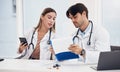 Doctors, healthcare and working together with clipboard for planning, research and medical schedule at desk in hospital Royalty Free Stock Photo