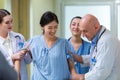 Doctors help support female patient while walking in hospital. Patient treatment physiotherapy have muscle weakness and paralysis Royalty Free Stock Photo