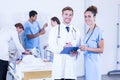 Doctors holding clipboard and smiling at camera Royalty Free Stock Photo