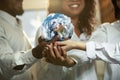 Doctors holding a world globe in hands, concept of world health, supporting