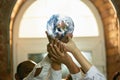 Doctors holding a world globe in hands, concept of world health, supporting