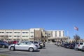 Doctors Hospital side view and parked cars American Flag