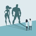 Doctors looking at superhero shadow on the wall. Hospital staff, nurses heroes fight coronavirus pandemic, epidemic, covid-19. Royalty Free Stock Photo