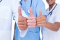 Doctors and nurse gesturing thumbs up Royalty Free Stock Photo
