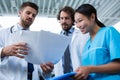 Doctors and nurse having a discussion over medical reports Royalty Free Stock Photo