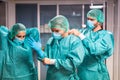 Doctors and nurse preparing to work in hospital for surgical operation during coronavirus pandemic outbreak - Medical workers