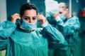 Doctors and nurse preparing to work in hospital for surgical operation during coronavirus pandemic outbreak - Medical workers Royalty Free Stock Photo