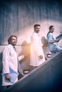 Doctors and nurse standing on staircase Royalty Free Stock Photo