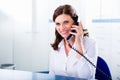 Doctors nurse with telephone in front desk