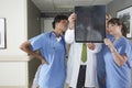 Doctors And Nurses Looking At X-Ray In Hospital