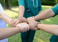 Doctors and nurses in a medical team stacking hands outdoor on t Royalty Free Stock Photo