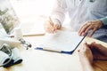 Doctors and patients sit and talk to the patient about medication. At the table near the window in the hospital. Royalty Free Stock Photo