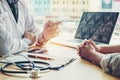 Doctors and patients sit and talk to the patient about medication. At the table near the window in the hospital. Royalty Free Stock Photo