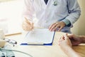 Doctors and patients sit and talk to the patient about medication. At the table near the window in the hospital. Royalty Free Stock Photo